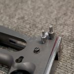 pins acting as a jig to insert the ear and hammer on a 1911 pistol