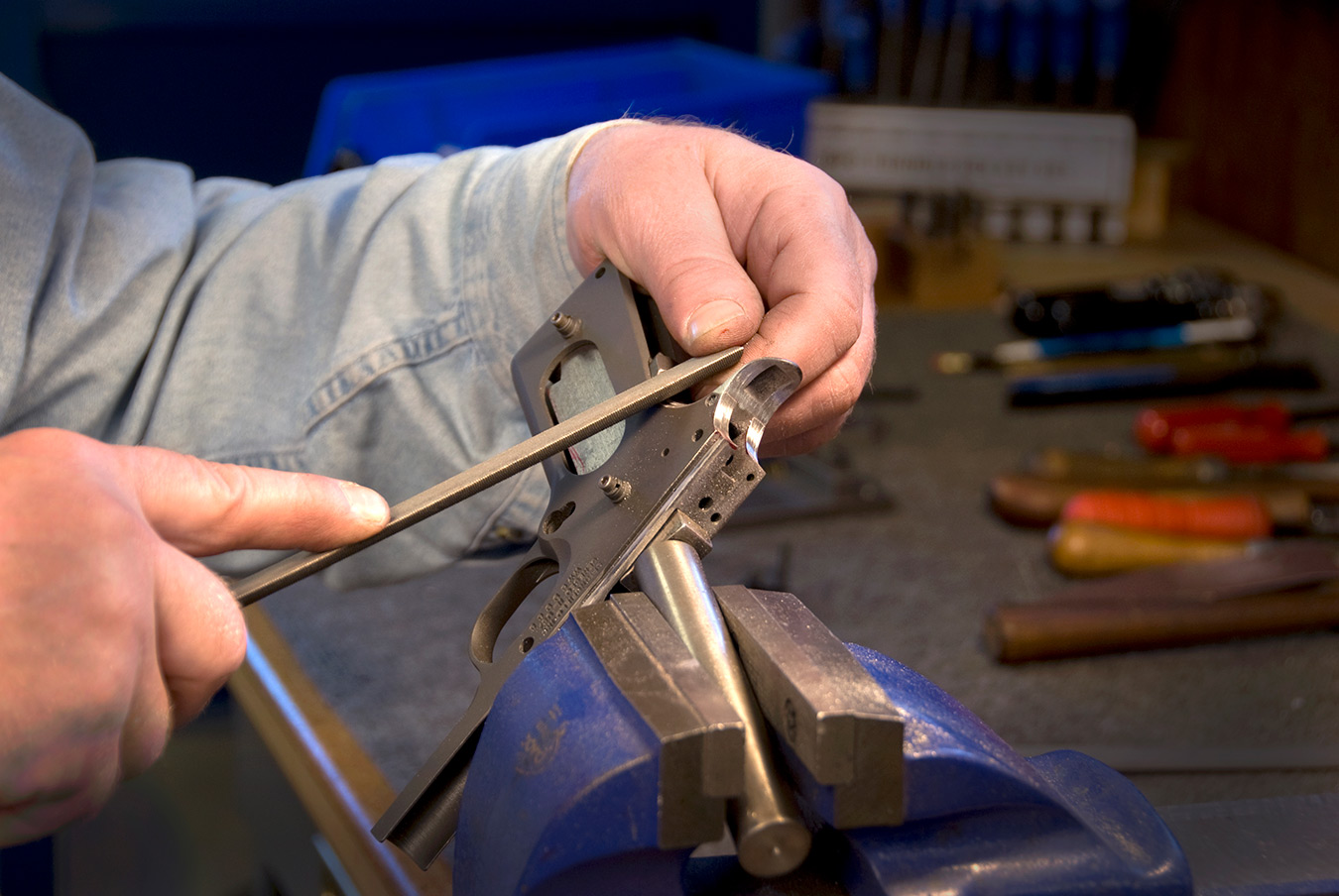 Hand filing the grip safety on a 1911 pistol to fit it to the frame