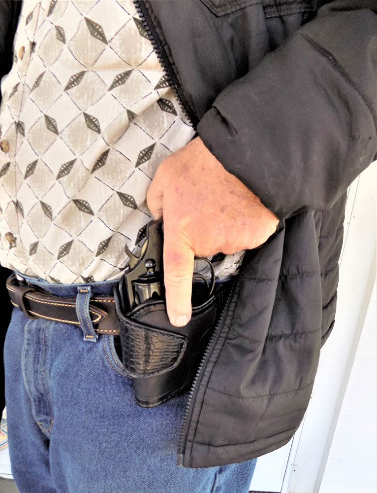 Man training for a perfect draw of a handgun from a concealed holster
