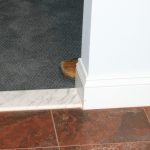 doorway showing a the toe of a shoe exposing a person who is hiding