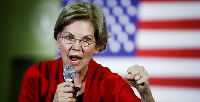 Elizabeth Warren with Clenched fist and mic rallying for new ammo tax
