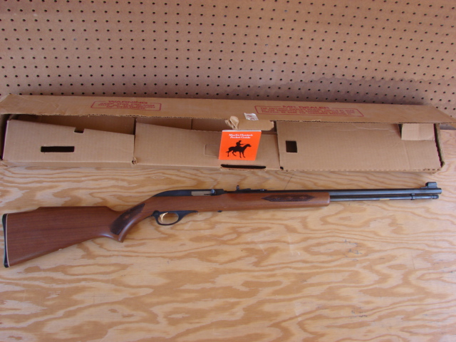 Marlin .22 LR rifle next to its box on a sheet of plywood showing one flaw in Florida's latest gun control referendum