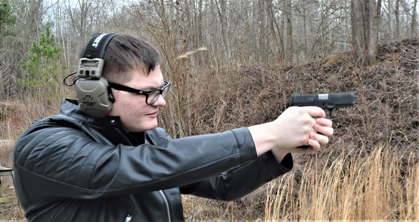 Man shooting the Taurus G3 pistol in rapid fire with spent cases in the air