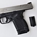 Springfield Armory XD-S 4.0 with slide locked to the rear and spare magazine