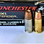 Winchester PDX1 Defender ammunition box and two loose rounds
