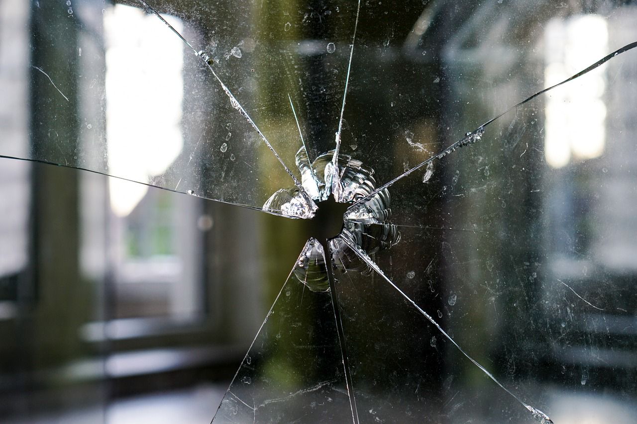 Glass window with a spider web style bullet hole
