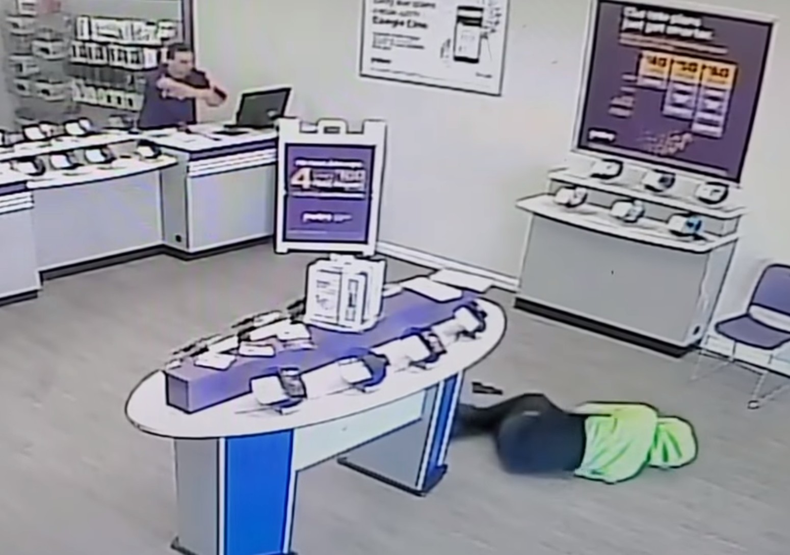 Downed armed robber being covered by an armed employee