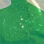 green silhouette target after being hit with buckshot